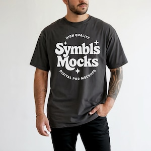 May include: A dark gray t-shirt with a white graphic design that says "High Quality Symbls Mocks Digital Pod Mockups".