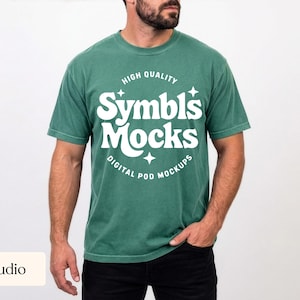 May include: A green t-shirt with the text "Symbls Mocks" in white, along with the words "High Quality" and "Digital Pod Mockups". The shirt is worn by a person in a studio setting.