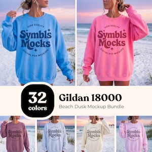 May include: A mockup bundle featuring Gildan 18000 sweatshirts in various colors. The image shows a light blue and a pink sweatshirt with the text "Symbls Mocks" and "Digital Pod Mockups". The bundle includes 32 colors.