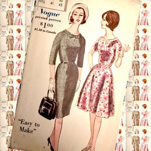 May include: Vintage Vogue printed pattern featuring illustrations of two dresses. One dress is a dark gray checkered sheath with a bow detail, the other is a pink floral print dress. The pattern is labeled "Easy to Make".
