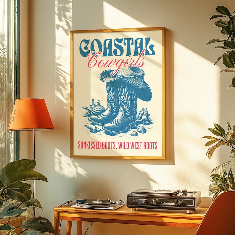 May include: A vintage-style poster with the text "Coastal Cowgirls" in blue and pink lettering. The poster features a pair of blue cowboy boots with a seashell design and the text "Sunkissed Boots, Wild West Roots".