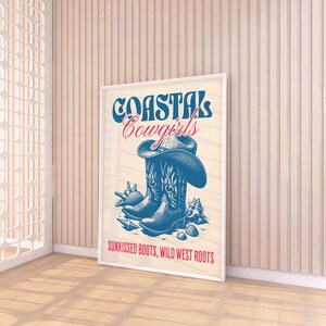 May include: A white framed poster with blue and red text that reads "Coastal Cowgirls" and a drawing of two blue cowboy boots with a brown cowboy hat on top of one boot. The text at the bottom of the poster reads "Sunkissed Boots, Wild West Roots."