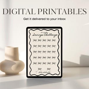 May include: A digital printable 52-week savings challenge tracker. The tracker is on a tablet screen with a white background and black text. The text says "52 weeks Savings Challenge" and has a line of 52 boxes for each week of the year. The last box says "Let's celebrate!"