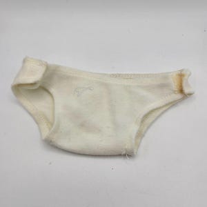 May include: A set of three ceramic mugs with a speckled, matte finish. The mugs are in shades of cream, light gray, and dark gray. Each mug has a simple, minimalist design, perfect for coffee or tea.