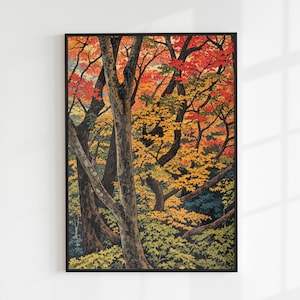 以下が含まれることがあります： 鮮やかな秋の森の風景を描いた、額装されたアートプリント。赤、黄色、緑の色合いのカラフルな葉を持つ木々が特徴です。幹は茶色と灰色で、暗い背景に配置されています。