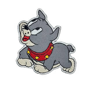 May include: Embroidered patch featuring a cartoon dog in a playful pose. The dog is gray with a red collar adorned with yellow studs. The patch has a white border, suitable for application on clothing or accessories.