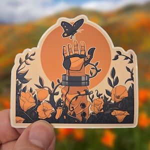 May include: A sticker featuring an illustration of a mechanical hand reaching for a butterfly. The hand is surrounded by orange flowers and vines, with a large orange sun in the background. The sticker has a white border.