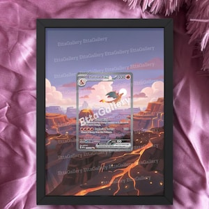 May include: A framed Charizard Pokémon card print. The card features a red and orange dragon over a desert landscape. The frame is black, and the background is a pink, textured fabric. Text on the card reads "Charizard ex 330".