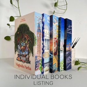 May include: A collection of individually sold books with colorful, artistic covers. The books feature illustrations of landmarks and scenes, including Big Ben, a Ferris wheel, and a red telephone booth. The title "Magnolia Parks" is visible on the first book.