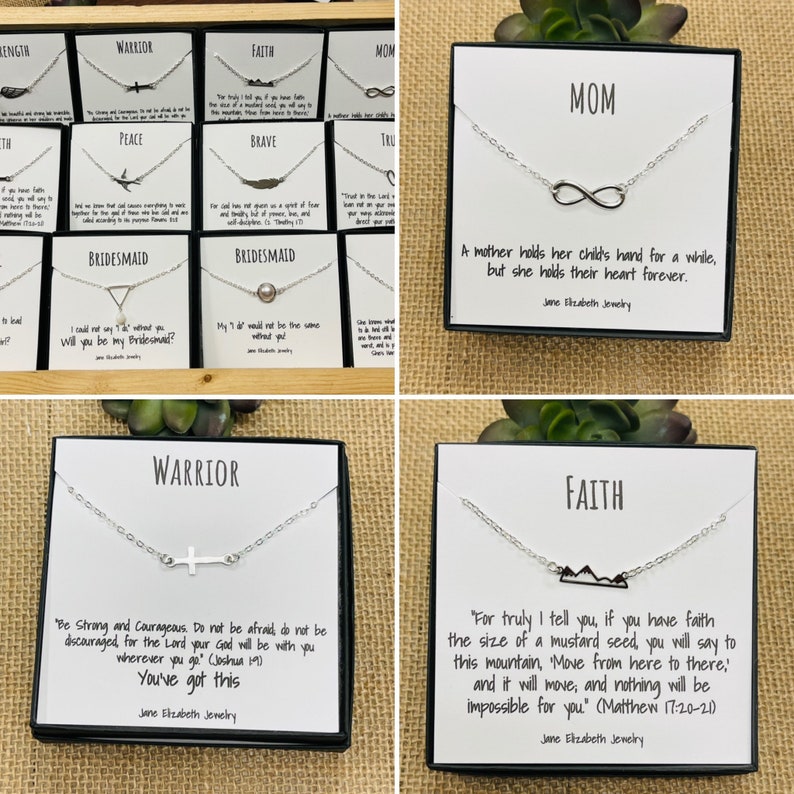 May include: A set of silver necklaces with different charms and inspirational quotes. The necklaces are displayed in black boxes with white backgrounds. The charms include a cross, an infinity symbol, and a mountain range. The quotes include "Be Strong and Courageous", "A mother holds her child's hand for a while, but she holds their heart forever", and "For truly I tell you, if you have faith the size of a mustard seed, you will say to this mountain, 'Move from here to there!' and it will move, and nothing will be impossible for you".