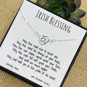 May include: A silver Celtic knot necklace with a card that reads "Irish Blessing" and a poem about blessings. The card also says "Sterling Silver" and "Jane Elizabeth Jewelry".