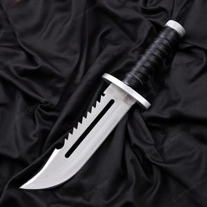 Handcrafted knife replica with brown leather sheath displayed outdoors