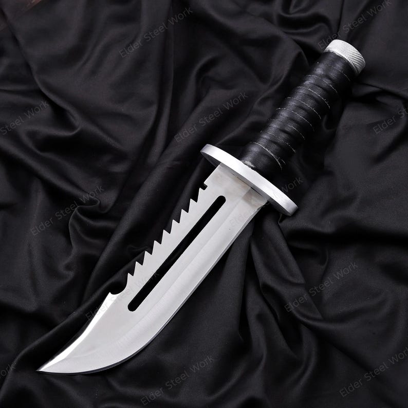 Handcrafted knife replica with brown leather sheath displayed outdoors