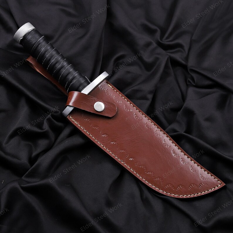 Cosplay knife replica with stitched leather sheath on green leaves