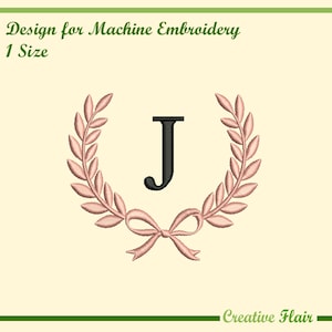 May include: An embroidered design featuring the letter "J" in black, encircled by a wreath of pink leaves and a bow. The text "Design for Machine Embroidery" and "1 Size" are at the top. The words "Creative Flair" are at the bottom.