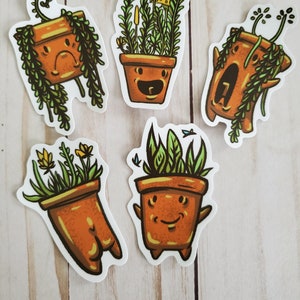 May include: A collection of five whimsical stickers featuring cartoon-style potted plants with expressive faces. The plants have green foliage and yellow flowers, and the pots are various shades of orange. Some stickers have vines or additional details.