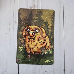 May include: A rectangular art print featuring a sad, cartoon-style dog with tears, set in a forest scene with mushrooms. The dog is golden-yellow with a sad expression. The background includes trees and a starry sky.