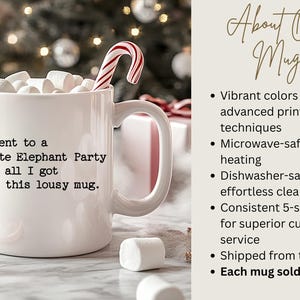 May include: A white ceramic mug featuring the black printed text: I went to a White Elephant Party and all I got was this lousy mug. The mug is filled with white marshmallows and a red and white striped candy cane, set against a festive background.