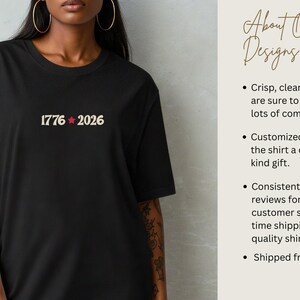 May include: Black t-shirt with the text "1776 2026" in a beige font with a red star. The shirt is a crew neck and has short sleeves. The text is centered on the chest.