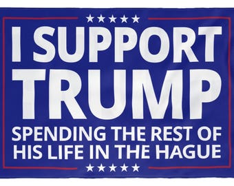 May include: A blue banner with white text that reads "I SUPPORT TRUMP" above "SPENDING THE REST OF HIS LIFE IN THE HAGUE". The banner has a red border and stars.