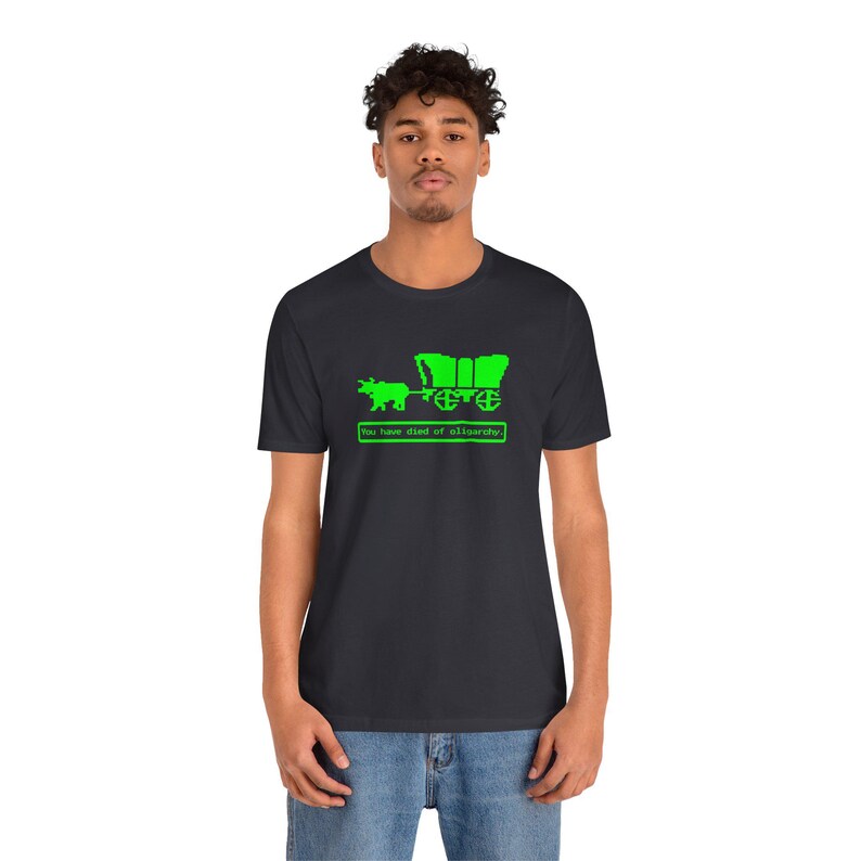 You Have Died of Oligarchy Oregon Trail TShirts Parody TShirts Funny Vintage Game Humorous Anti Trump Elon Musk Dark Grey Tees Green Bull and Wagon Resist