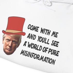 May include: White hoodie with a red and white hat on a person's head. The text on the hoodie reads "Come with me and you'll see a world of pure misinformation."