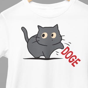 Cat Knocking DOGE Off Table Funny T-Shirts Anti Trump Anti Elon Musk DOGE Humorous Cute Cats Tees Gifts Hilarious