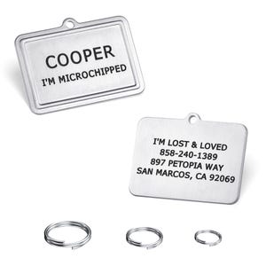 May include: Two rectangular, silver pet ID tags with rounded corners. One tag reads "COOPER" and "I'M MICROCHIPPED." The other tag has contact information: "I'M LOST & LOVED," a phone number, address, and city. Three silver split rings are also included.