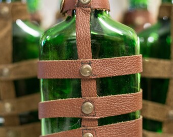 Leather wrapped glass flask.