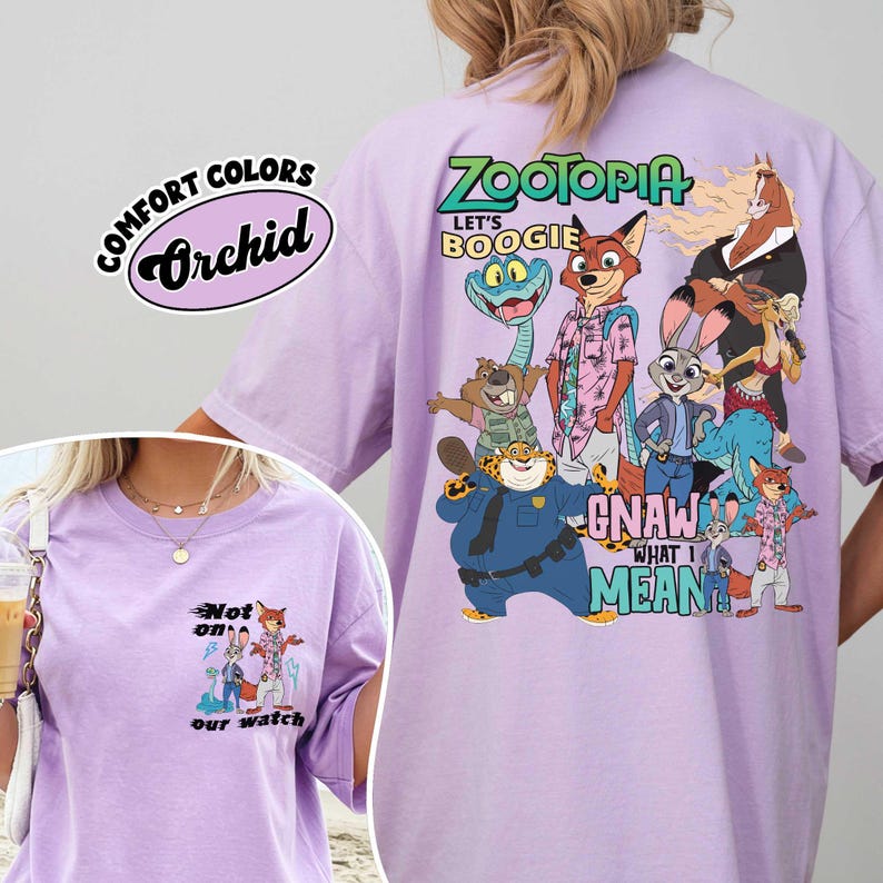 May include: A light purple t-shirt featuring characters from the movie Zootopia. The back of the shirt has the words "Zootopia" and "Let's Boogie" with various cartoon characters. The front of the shirt has the words "Not on our watch".