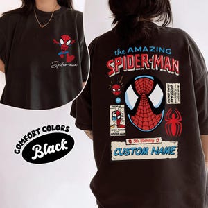 May include: Black t-shirt featuring Spider-Man graphics. The front displays a small Spider-Man graphic and the text "Spider-man". The back features "The Amazing Spider-Man" text, a large Spider-Man mask, and the text "Custom Name".
