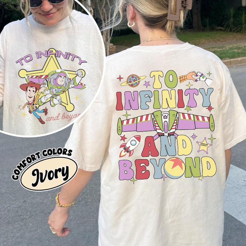 May include: Ivory-colored long-sleeve shirt with a graphic featuring the phrase "To Infinity and Beyond." The front design includes Woody, Buzz Lightyear, and a star. The back design has a rocket, planet, and the same phrase.