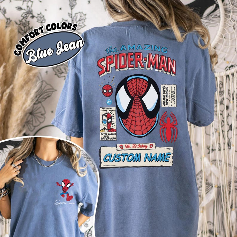 May include: Blue jean colored t-shirt featuring the Amazing Spider-Man. The back of the shirt has a large Spider-Man graphic, comic book style images, and the text "5th Birthday" and "Custom Name". The front of the shirt has a small Spider-Man graphic.