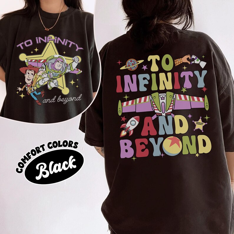 May include: Black t-shirt with a colorful graphic featuring characters and text from the movie "Toy Story." The front design includes Woody, Buzz Lightyear, and the words "To Infinity and Beyond." The back design repeats the phrase.
