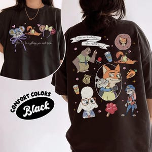 Puede incluir: Camiseta negra Comfort Colors con personajes de dibujos animados y el texto "You can be anything you wish to be." La parte trasera de la camiseta muestra varios personajes y el texto "You can be whatever, you wish to be."