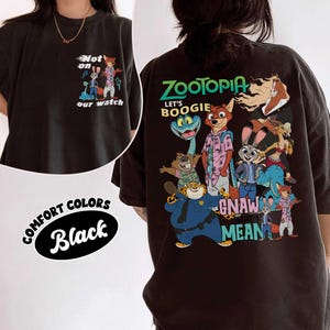 May include: Black comfort colors t-shirt featuring Zootopia characters. The front has the text "Not on our watch" with cartoon characters. The back has the text "Zootopia Let's Boogie Gnaw Mean" with cartoon characters.