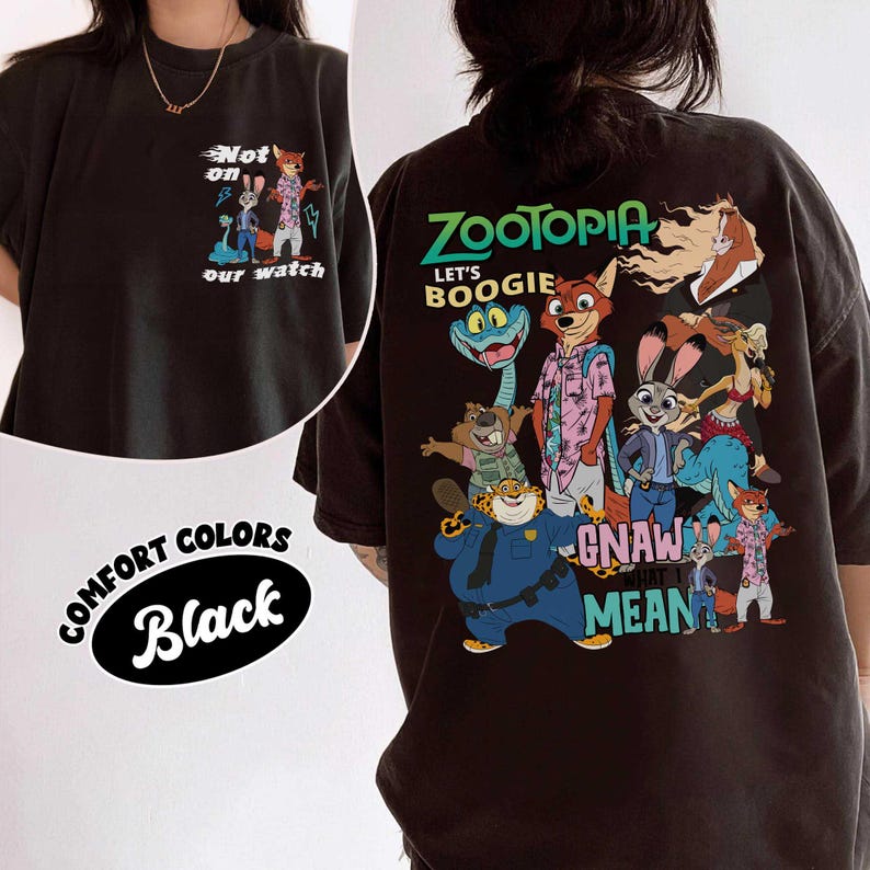 May include: Black comfort colors t-shirt featuring Zootopia characters. The front has the text "Not on our watch" with cartoon characters. The back has the text "Zootopia Let's Boogie Gnaw Mean" with cartoon characters.