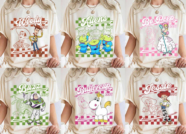 May include: Cream-colored t-shirts featuring various Toy Story characters like Woody, Aliens, Bo Peep, Buzz, Buttercup, and Jessie. Each design includes the character's name and the year 1995 within a checkered frame.