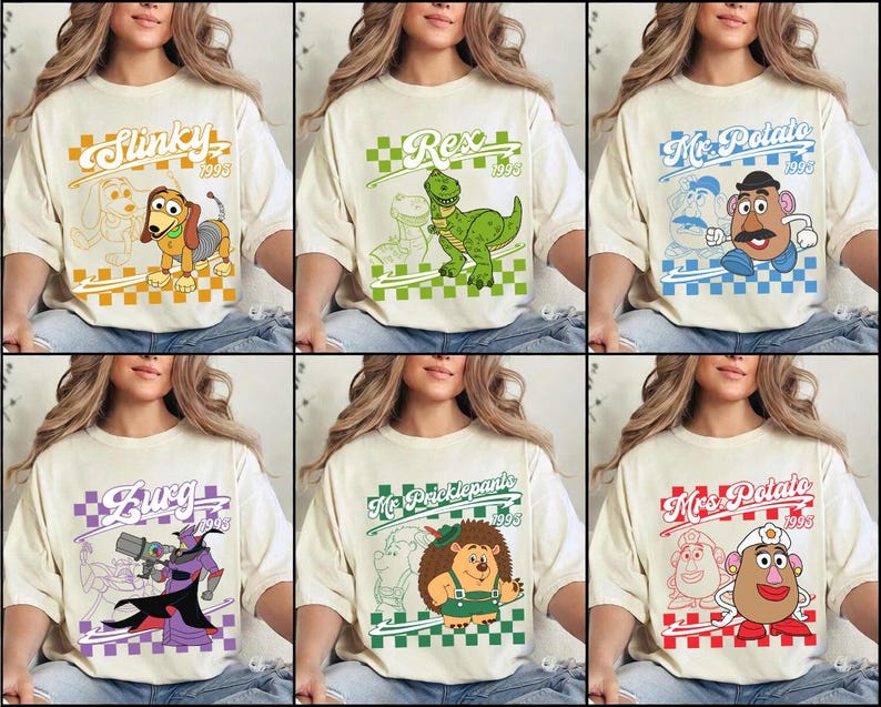 May include: Cream-colored t-shirts featuring cartoon characters from the movie Toy Story. Each shirt has a different character design with the character's name and the year 1995 in a colored checkered box. Characters include Slinky, Rex, Mr. Potato Head, Zurg, Mr. Pricklepants, and Mrs. Potato Head.