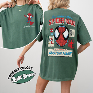 May include: Light green t-shirt featuring a Spider-Man graphic on the front and back. The front has a small Spider-Man cartoon and the text "Spider-man". The back has a large Spider-Man graphic with the text "The Amazing Spider-Man" and "Custom Name".