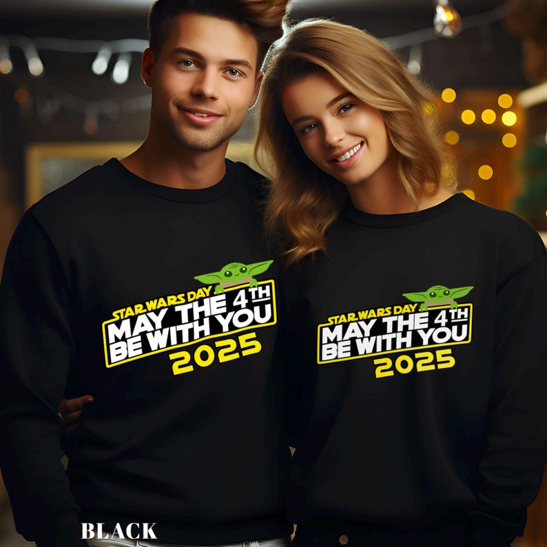 May include: Black sweatshirts featuring the text "STAR WARS DAY MAY THE 4TH BE WITH YOU 2025" in yellow and white, with a green cartoon character. The word "BLACK" is at the bottom of the image.