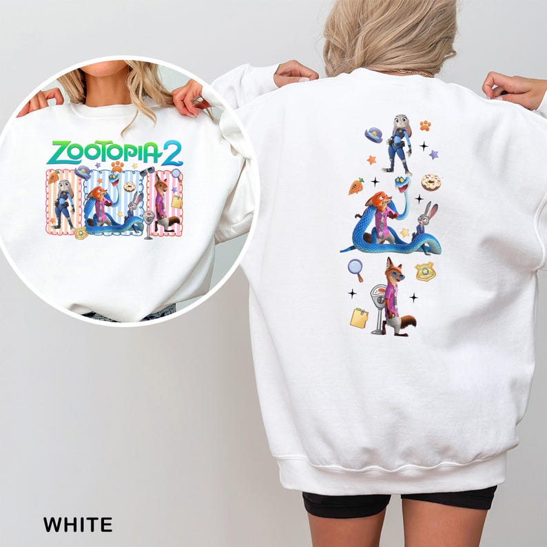 May include: White sweatshirt featuring colorful graphics from Zootopia 2. The front displays the title and characters, while the back showcases additional characters and themed elements. The word "WHITE" is printed at the bottom.