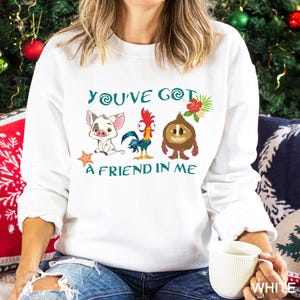 May include: White sweatshirt with a green graphic of characters from the movie Moana. The graphic says "You've Got a Friend in Me".