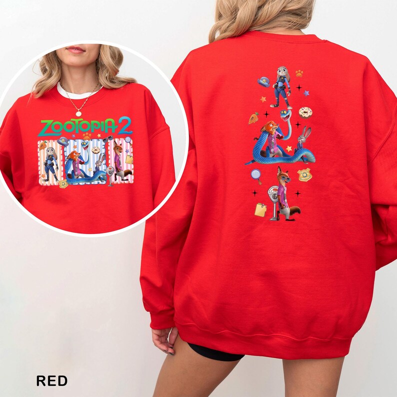 May include: Red sweatshirt featuring characters from Zootopia 2. The front has the title "Zootopia 2" with character illustrations. The back displays additional character graphics, including a fox in a pink suit and a bunny. The word "RED" is at the bottom.