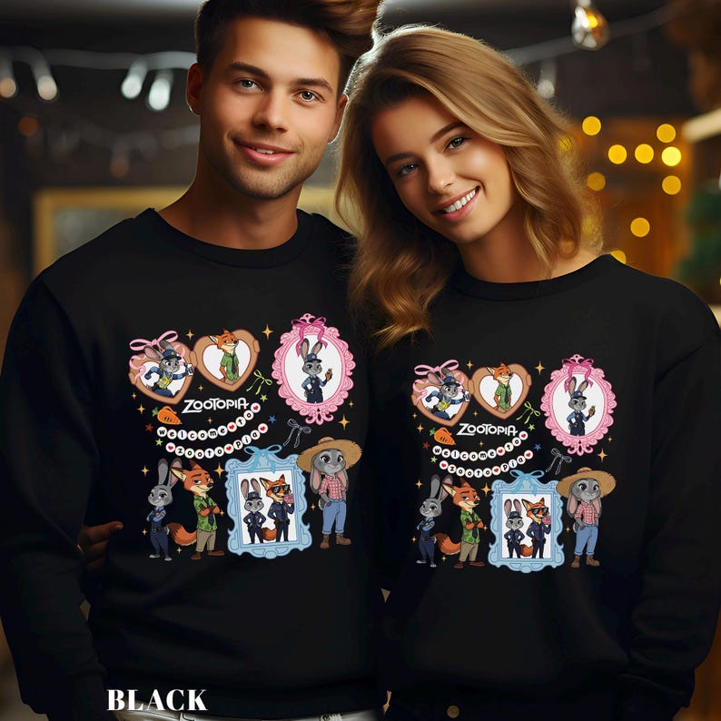 Pode incluir: Camisolas pretas com um design gr&aacute;fico colorido do filme Zootopia. O design inclui personagens em molduras e cora&ccedil;&otilde;es, com a palavra "Zootopia" no centro. A palavra "BLACK" est&aacute; impressa na parte inferior.