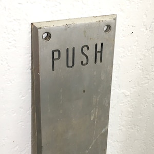 May include: A rustic wooden sign with the text "Welcome to our home" in white lettering. The sign features a distressed finish and a simple, inviting design, perfect for a front porch or entryway.