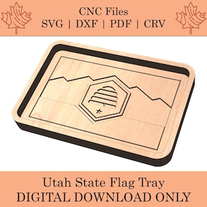 May include: A wooden tray with a black border, featuring a laser-cut design of the Utah state flag. The flag depicts a beehive with a star in the center, surrounded by mountains.