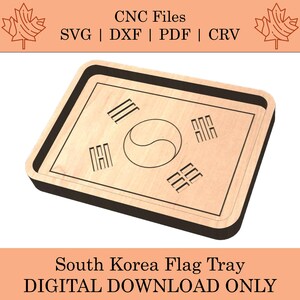May include: A wooden tray with a black border, featuring the South Korean flag design. The flag is engraved on the tray's surface, showcasing the Taegeuk symbol and four black trigrams.