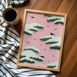 May include: A framed print with a pink background and a repeating pattern of green and white clouds with black birds flying across the sky.