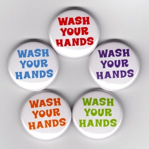May include: Five round buttons with the text "Wash Your Hands" in different colors: red, blue, purple, orange, and green.